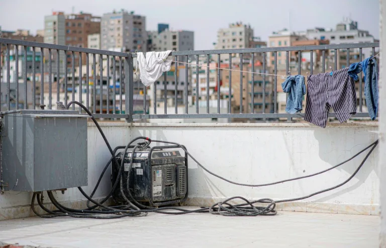 Step down transformer beside a backup generator on a Beirut apartment balcony