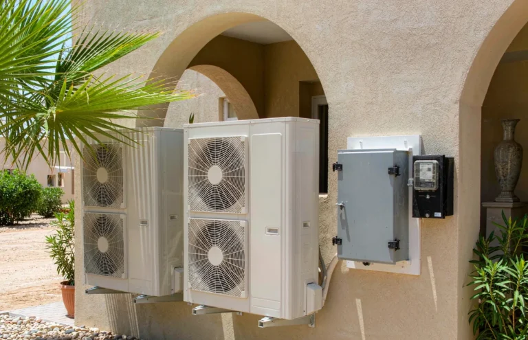Step down transformer mounted on a villa wall in Bahrain beside air conditioning units